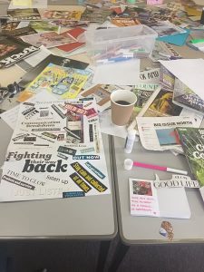 magazines on a table with clippings cut out to make collage